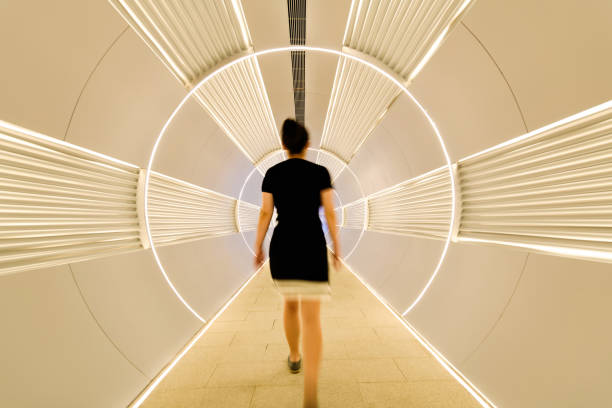 istock Woman walking in corridor tunnel 2204697458