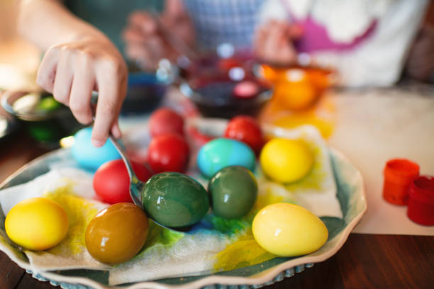 istock Family painting Easter eggs 2204697503