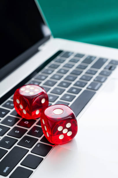 istock Red dices on laptop keyboard 2204697581