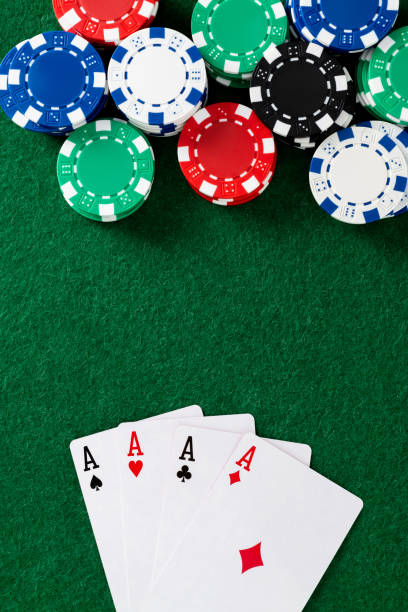istock Four aces and gambling chips on the table 2204697772