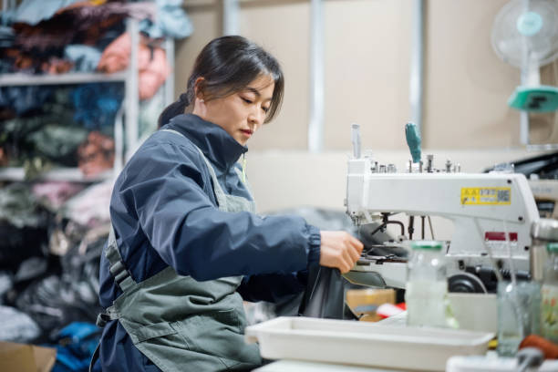 istock Asian female blue-collar workers are in the sewing workshop 2204698566