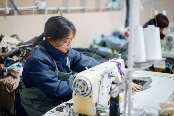 istock Asian female blue-collar workers are in the sewing workshop 2204698583