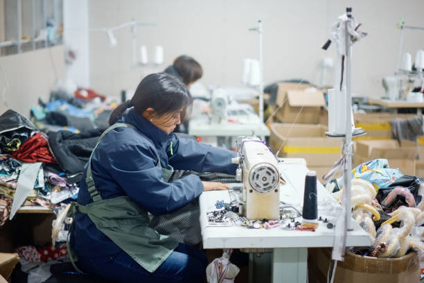 istock Asian female blue-collar workers are in the sewing workshop 2204698588