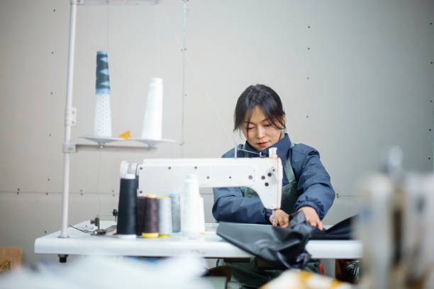 istock Asian female blue-collar workers are in the sewing workshop 2204698721