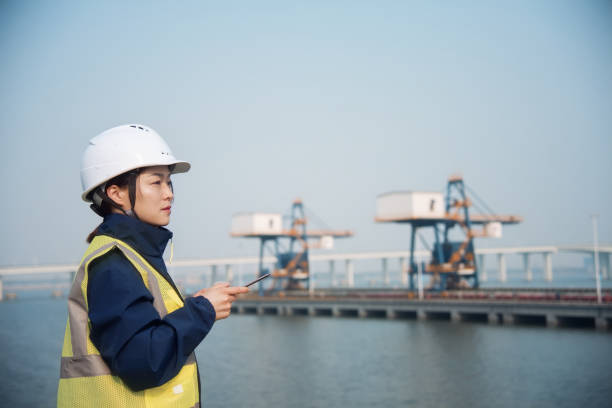 istock asian female engineer working with digital tablet at port 2204698840