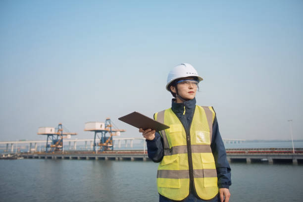 istock asian female engineer working with digital tablet at port 2204699030