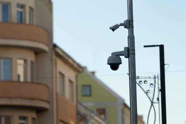 istock Surveillance cameras are securely mounted high on a tall pole at outdoor area 2204699104