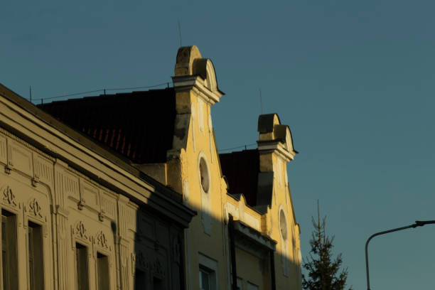 istock Classic houses featuring sloping roofs during a beautiful sunset 2204700315
