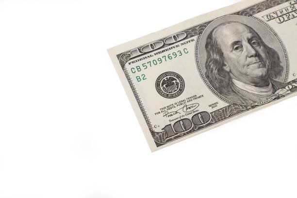 istock Part of a one hundred dollar bill in a close up view on a white background 2204701003