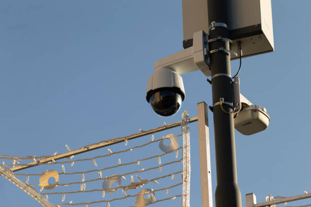 istock Surveillance cameras are securely mounted high on a tall pole at outdoor area 2204702076
