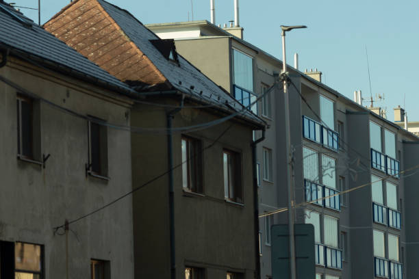 Facade of a residential building with windows, showcasing modern urban design. The architecture reflects functionality and aesthetics, blending seamlessly into the urban landscape.