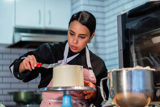 istock A young chef prepares a cake from the kitchen of the house using his utensils 2204703688