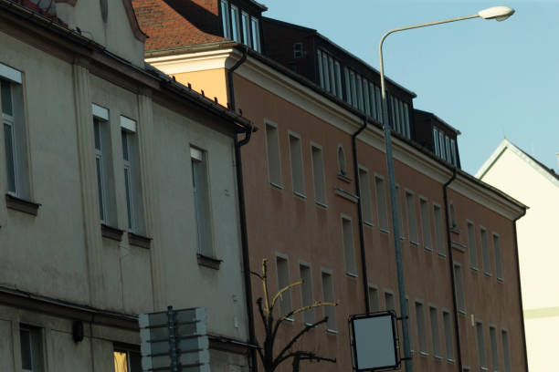 Facade of a residential building with windows, showcasing modern urban design. The architecture reflects functionality and aesthetics, blending seamlessly into the urban landscape.