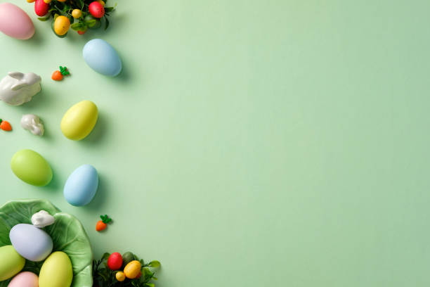 istock Happy Easter greeting card design. Pastel Easter eggs, with bunny and decorations on light green background. Flat lay, top view 2204705279