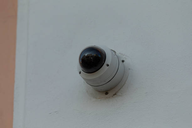 istock A Security Camera is Attached to the Outside of a Building Structure 2204706218