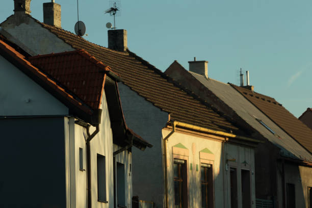 istock A line of classic houses featuring sloping roofs during a beautiful sunset 2204706372