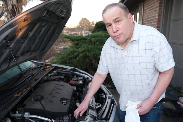 istock Autistic Male checking fluids in a car 2204706418