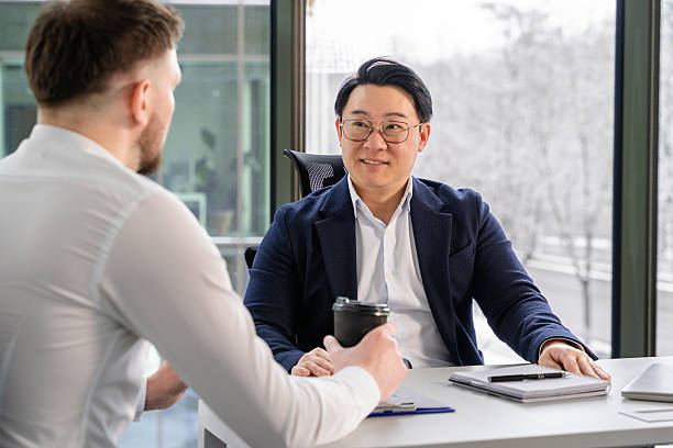 istock Professional Business Meeting Between Colleagues in a Modern Office Setting 2204706483