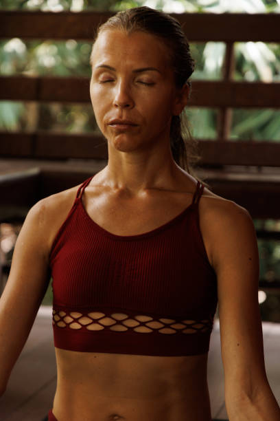 istock Woman practicing meditation indoors in a serene and focused state 2204706858