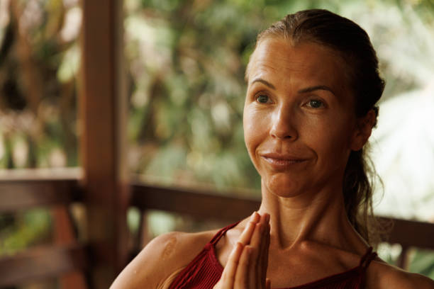 istock Woman meditating outdoors with a calm expression and a serene natural background 2204707340