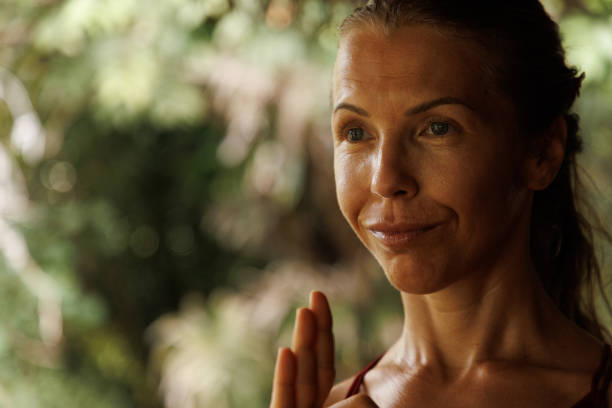 istock A woman practicing mindfulness and meditation outdoors in a natural serene setting 2204707366