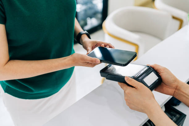 istock Woman Using NFC Mobile Payment at Pharmacy Counter 2204707701