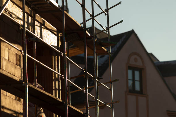 istock The Scaffolding Present at a Building Construction Site During Sunset 2204708127