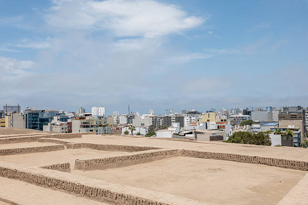 istock Ancient Ruins Overlooking Modern City Skyline 2204709118