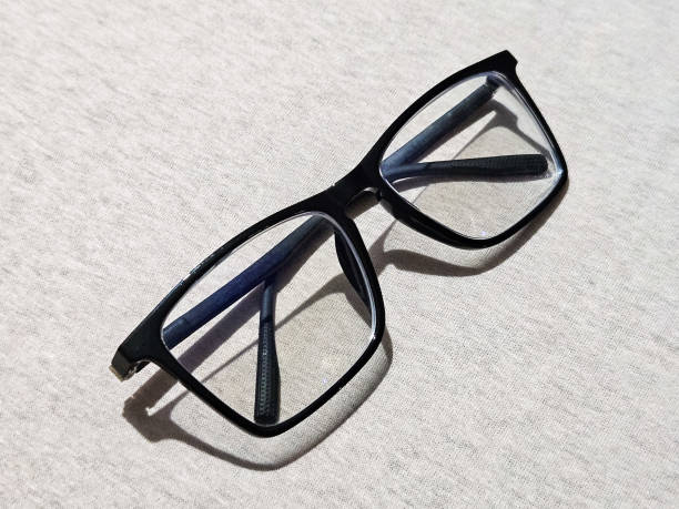 istock prescription glasses with glossy black frames on yellow background. vision concept. ophthalmologist 2204709794