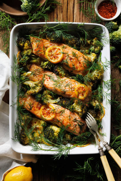 istock Baked salmon fillets and broccoli in casserole dish,  top view 2204713896