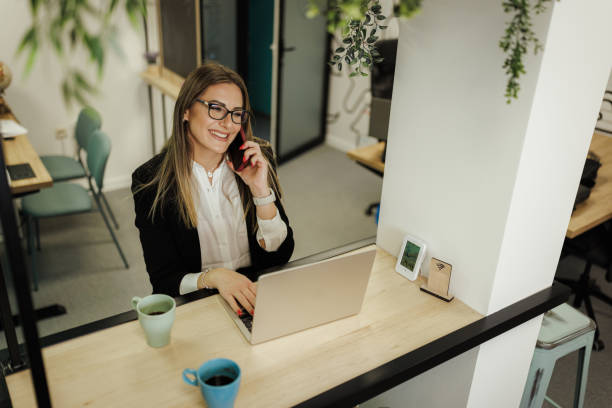 istock Businesswoman Multitasking in Modern Office 2204714154