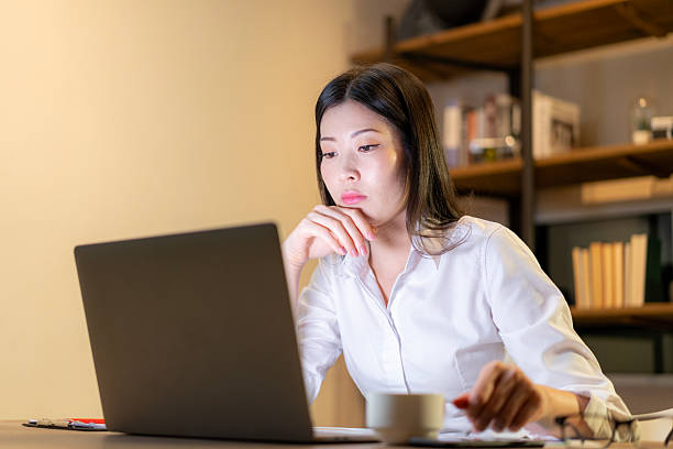 istock The young woman is exhausted from working late. 2204715008