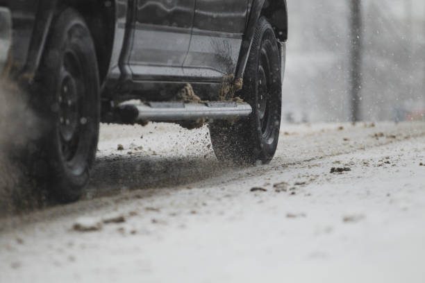 istock Truck tires driving down a snow covered road. 2204717783