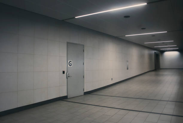 istock Empty concrete hallway with single locked door with 'G' on the front. 2204718032