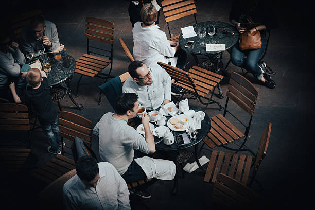 Women talking over a cup of coffee at a restaurant.