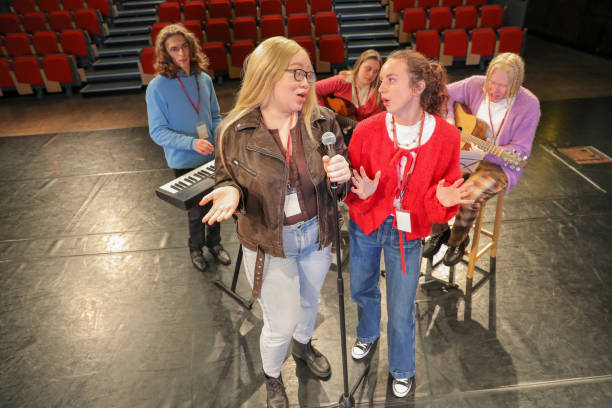 Group of people with disabilities performing music on stage during rehearsal