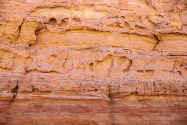 texture of orange stone rock in a colored canyon closeup