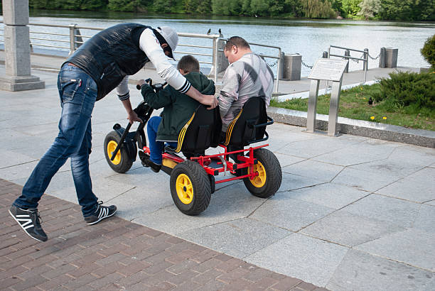 People rent a velomobile in Victory Park in Minsk, Belarus