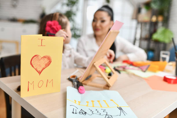 istock Creative Daughter Designing Mother's Day Cards For Mother 2204729200