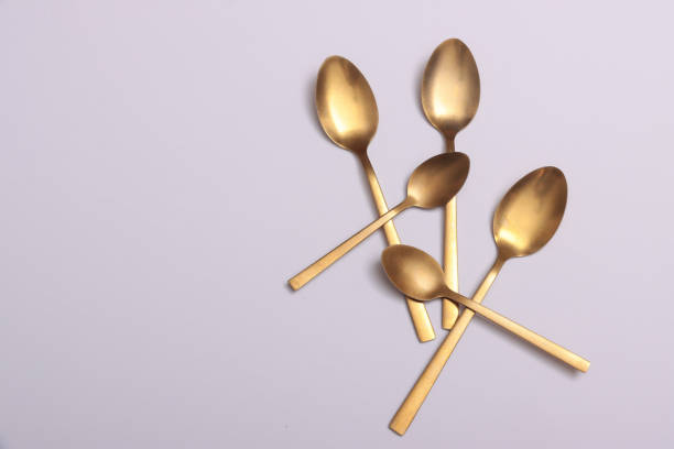 istock Gold cutlery on white shinny silk satin 2204729309