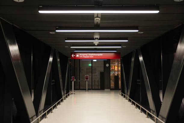 istock Modern Airport Walkway with Direction Signs at Night 2204729328