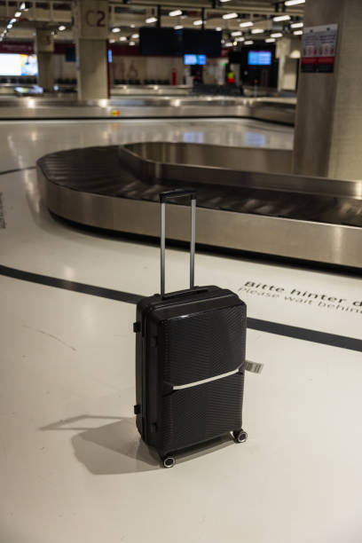 istock Suitcases at Airport Baggage Claim Area 2204729671