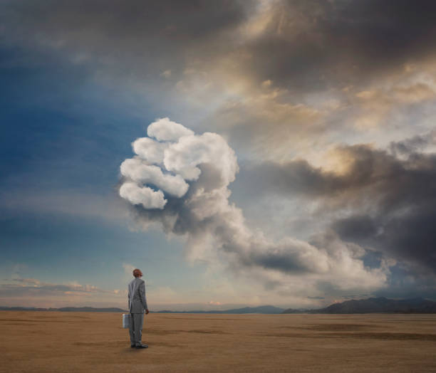 istock Conceptual image of businessman looking up at storm cloud 2204729783