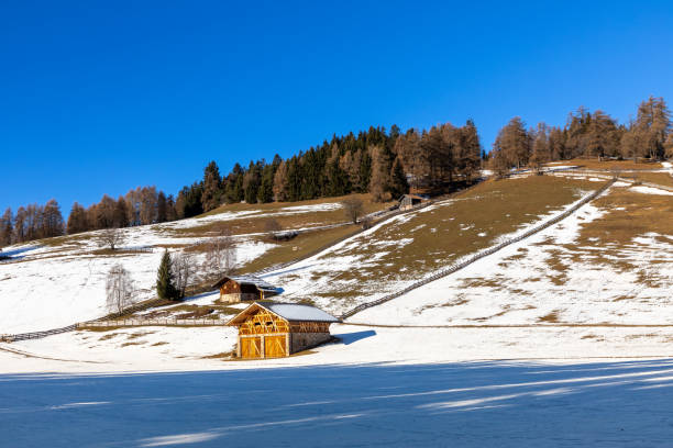 A Wooden hut in dolomites snow panorama landscape wooden hut val badia armentarola hill