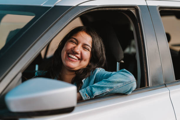 istock Smiling latin woman in car 2204731836