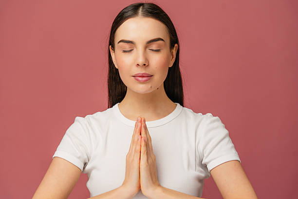 istock Person Practicing Peaceful Mindfulness with Hands Pressed in Prayer Position 2204732281