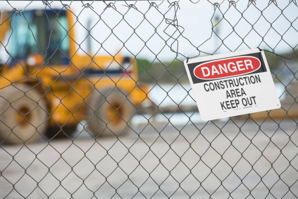 istock Danger warning sign at a construction site with a bulldozer in the background 2204732571