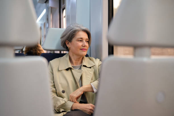 istock Thoughtful mature woman looking out the window while traveling by train 2204734521