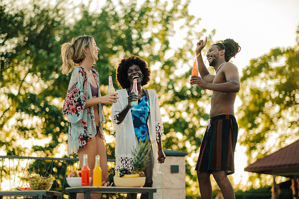 istock Friends enjoying drinks and dancing at a pool party 2204734680