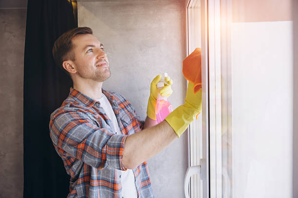 istock Man Cleaning Windows at Home wearing Protective Gloves 2204737236